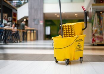 Caution wet floor - yellow mopping cart at a shopping mall